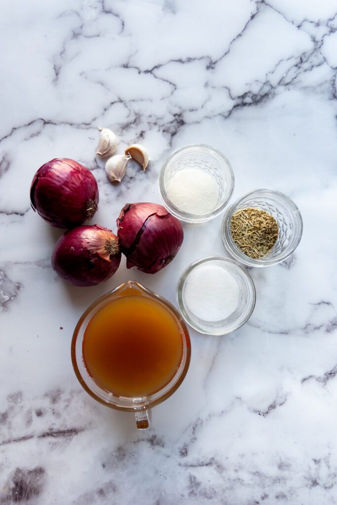 display of ingredients: apple cider vinegar, herbs, red onions, garlic and monk fruit sweetner